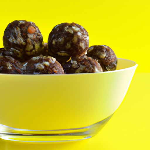 A bowl of energy balls with a bright yellow background.